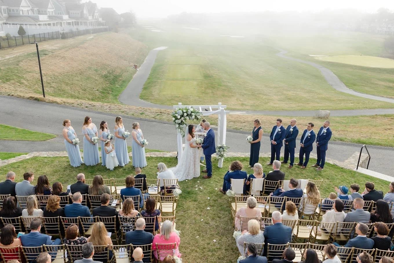 Outdoor wedding ceremony with an arch backdrop
